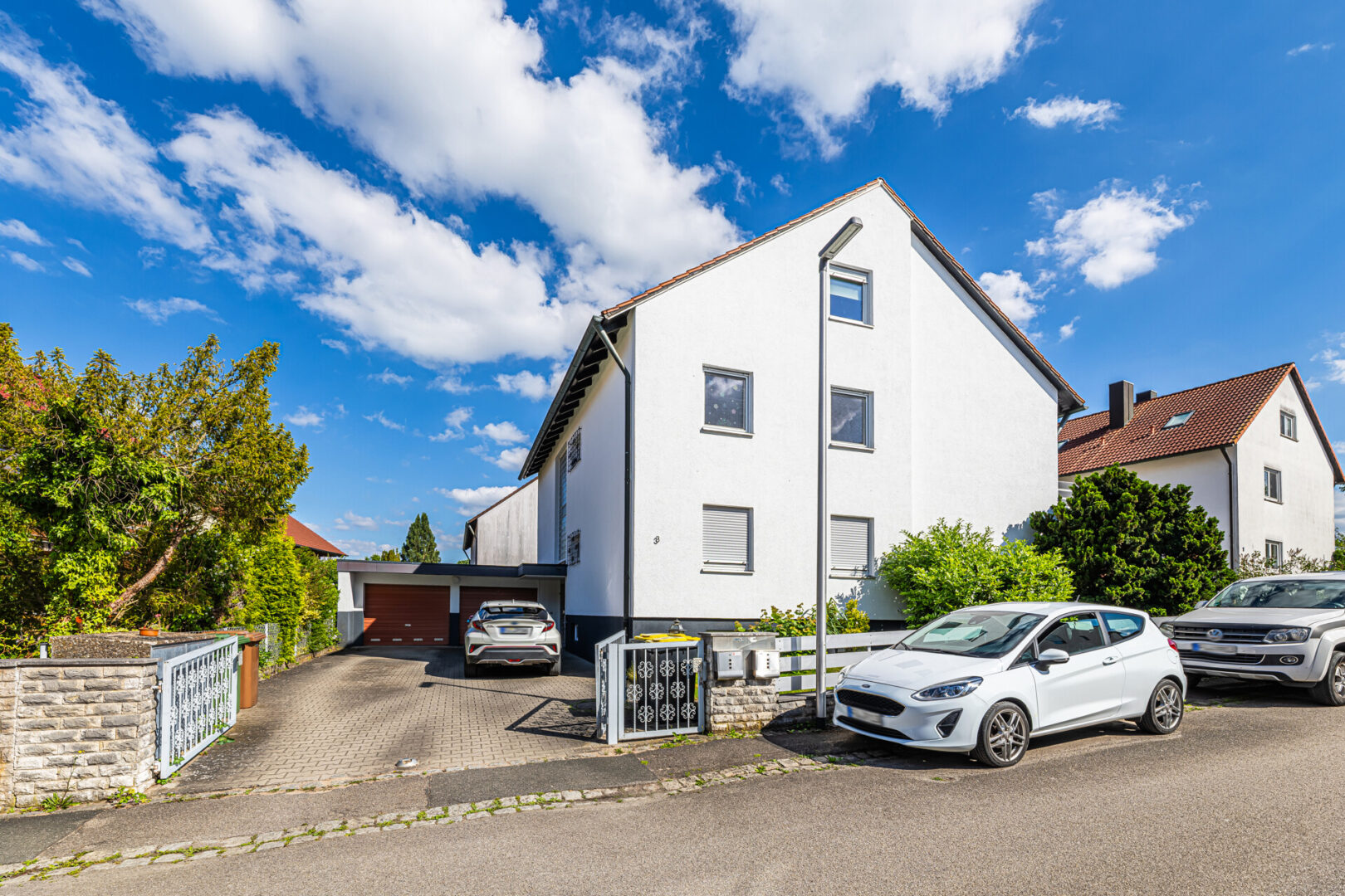 Hausansicht mit Stellplätzen